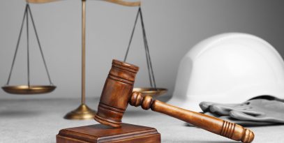 accident,at,work.,gavel,,safety,equipment,and,scales,on,grey